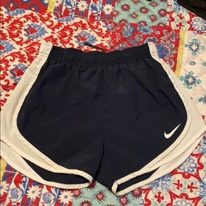 Navy blue and white Nike running shorts